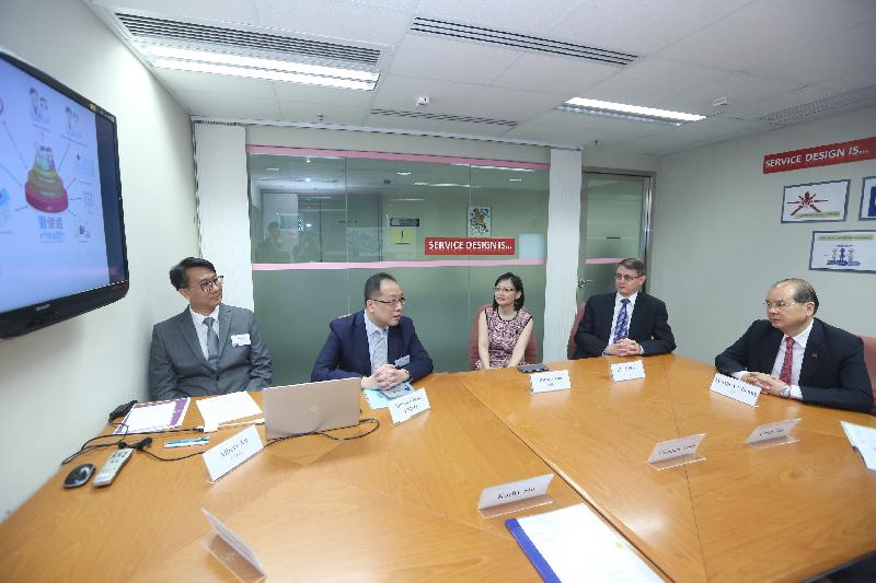 The Chief Secretary for Administration, Mr Matthew Cheung Kin-chung (first right), today (September 15) visits the Efficiency Unit (EU) and receives a briefing on the EU's work to drive cross-departmental initiatives. Also present are the Head of the EU, Mr Kim Salkeld (second right), and the Deputy Head of the EU, Mrs Patricia Lau (third right).