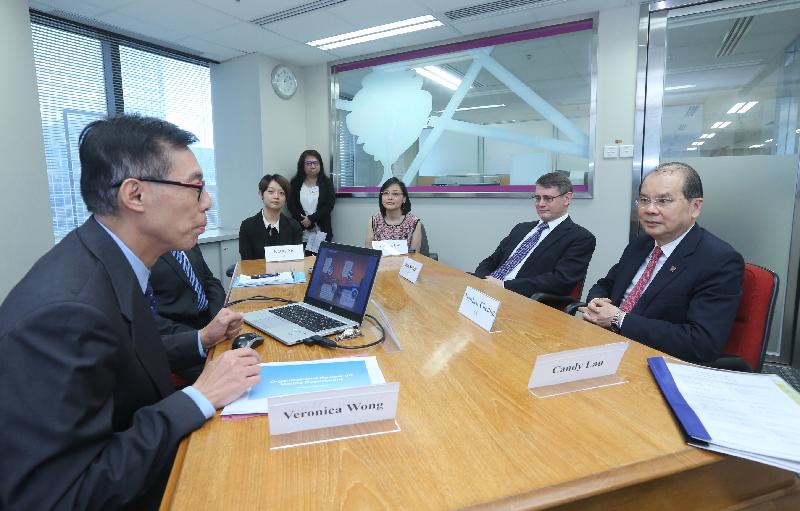 The Chief Secretary for Administration, Mr Matthew Cheung Kin-chung (first right), today (September 15) visits the Efficiency Unit (EU) and receives a briefing on the Unit's services provided to government departments in organisational review. Also present are the Head of the EU, Mr Kim Salkeld (second right), and the Deputy Head of the EU, Mrs Patricia Lau (third right).