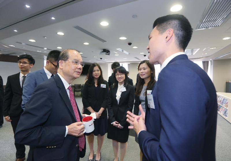 The Chief Secretary for Administration, Mr Matthew Cheung Kin-chung (left), chats with staff of the Efficiency Unit today (September 15).