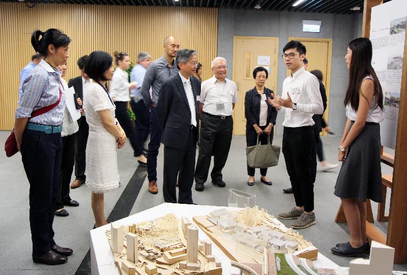 The Greening, Landscape and Tree Management Section of the Development Bureau organised an exhibition held under "Liveability by Design" Studio Initiative. Photo shows the Permanent Secretary for the Development (Works), Mr Hon Chi-keung (centre) and the Deputy Secretary for Development (Works), Ms Joey Lam (second left), being briefed by the participating student on his work concept. Looking on is the Head of Greening, Landscape and Tree Management Section of the Development Bureau, Ms Deborah Kuh (first left).