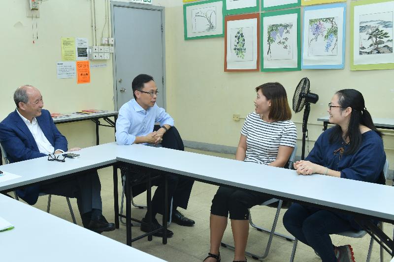 The Secretary for Constitutional and Mainland Affairs, Mr Patrick Nip (second left), visited Tai Po Pun Chung Community Education Center today (September 27) where he is pictured chatting with some newly arrived women to understand more about their lives in Hong Kong. Also pictured is the Chairman of the Tai Po District Council, Mr Cheung Hok-ming (first left).
