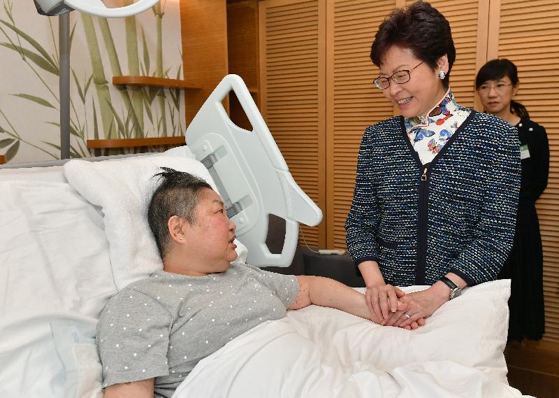 The Chief Executive, Mrs Carrie Lam (right), chats with a patient at the Jockey Club Home for Hospice in Sha Tin today (September 28).