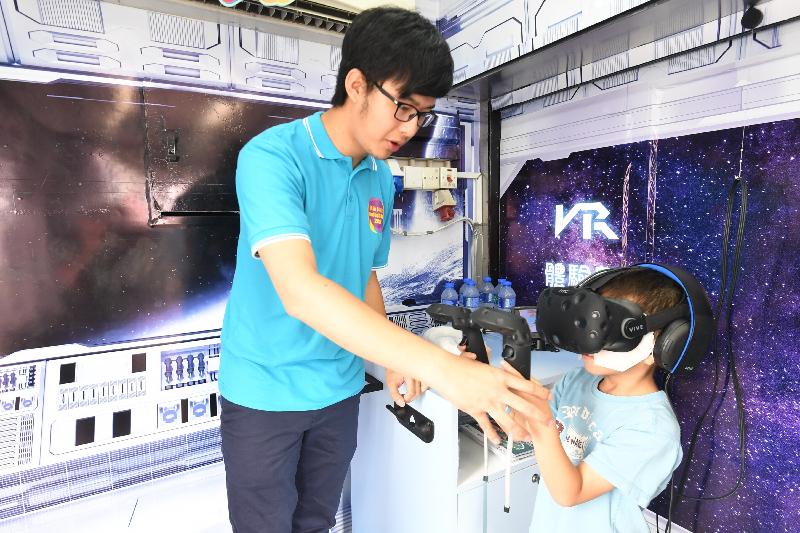 The Innovation and Technology Commission today (September 30) launched the InnoTech Month 2017. Photo shows a member of the public trying out the fun-filled virtual reality (VR) game and activities on the promotional truck "InnoForce".