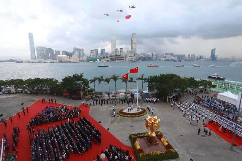 The disciplined services and the Government Flying Service perform a sea parade and a fly-past at the flag-raising ceremony in celebration of the 68th anniversary of the founding of the People's Republic of China at Golden Bauhinia Square in Wan Chai this morning (October 1).