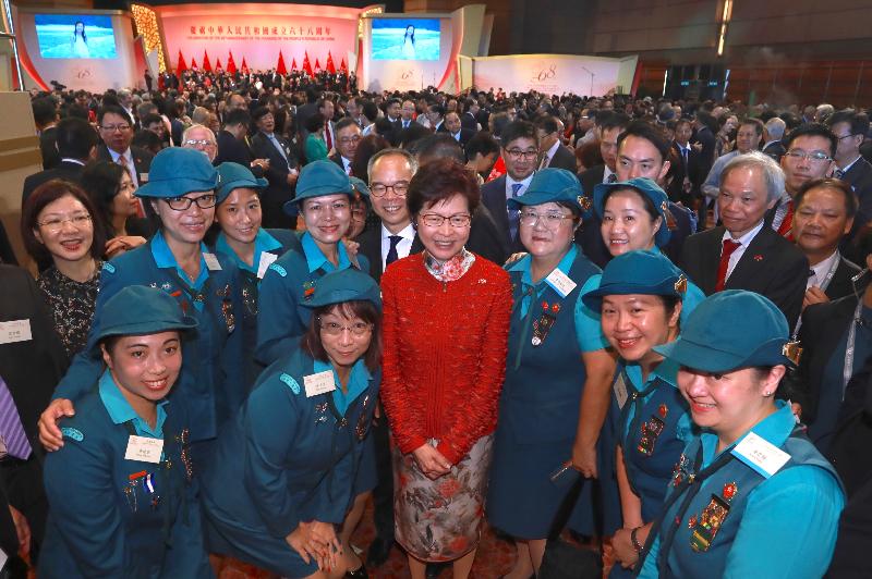 The Chief Executive, Mrs Carrie Lam (front row, third left), is pictured with members of uniformed groups and other guests at a reception in celebration of the 68th anniversary of the founding of the People's Republic of China at the Grand Hall of the Hong Kong Convention and Exhibition Centre this morning (October 1).