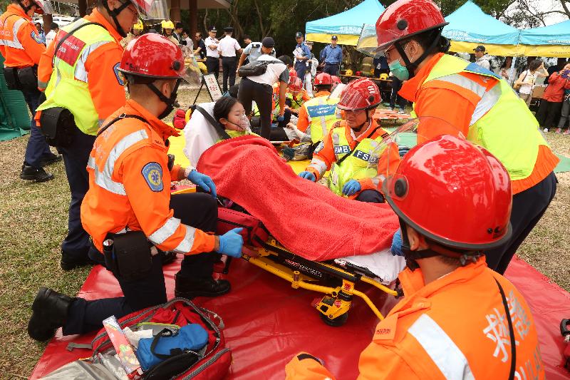 Ambulance personnel handle an injured person during an inter-departmental vegetation fire and mountain rescue operation exercise today (October 19).