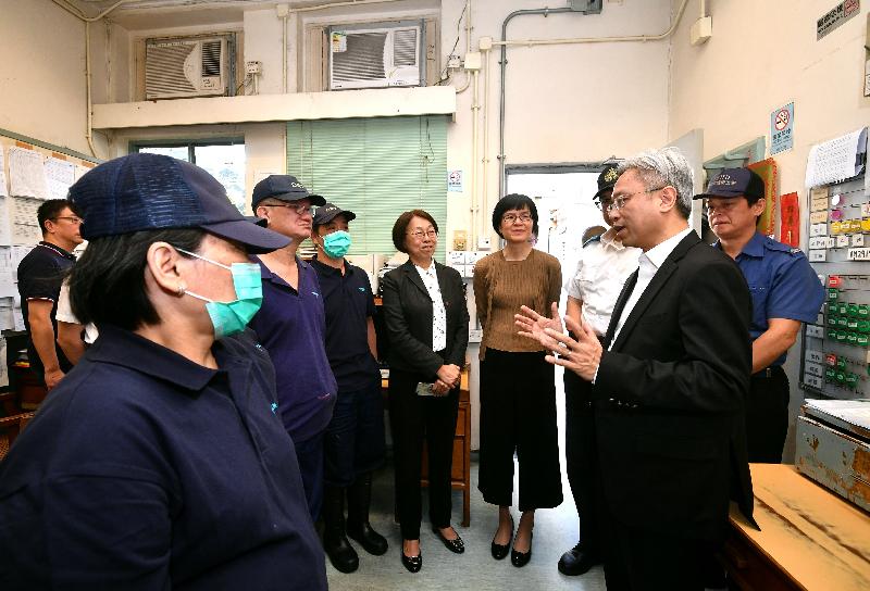公務員事務局局長羅智光（前右）今日（十月二十四日）到訪食物環境衞生署，其間聽取屍體處理隊人員講解他們的工作。