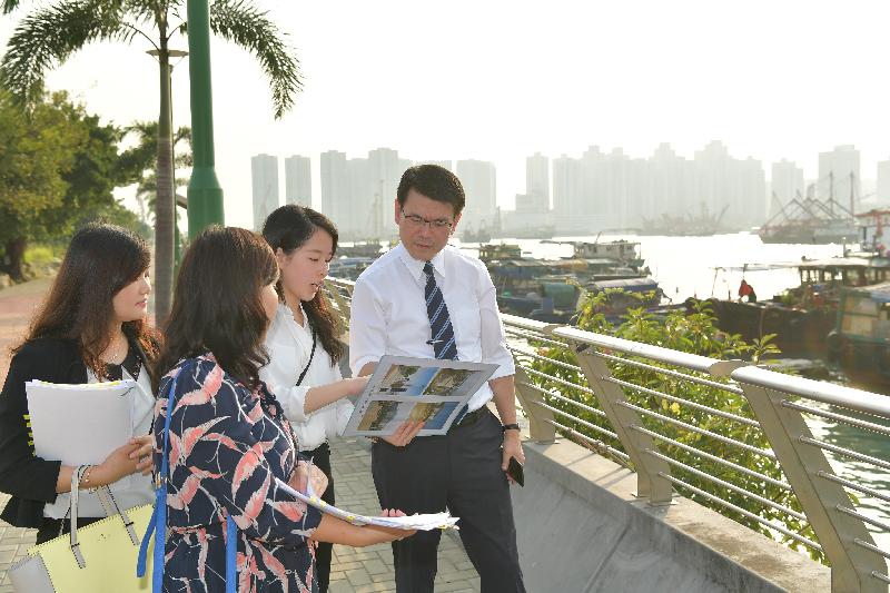 The Secretary for Commerce and Economic Development, Mr Edward Yau (first right), learns about the future development plan for the location adjacent to Castle Peak Bay Typhoon Shelter during his visit to Tuen Mun District today (October 24).