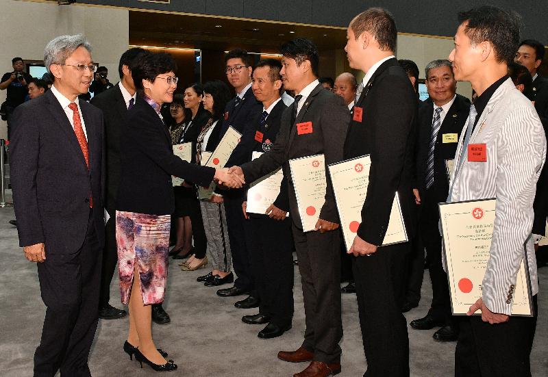 The Chief Executive, Mrs Carrie Lam, attended a cocktail reception after the Secretary for the Civil Service's Commendation Award Presentation Ceremony at the Central Government Offices today (November 2). Photo shows Mrs Lam (second left), accompanied by the Secretary for the Civil Service, Mr Joshua Law (first left), congratulating an award recipient.
