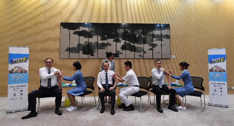 The Chief Secretary for Administration, Mr Matthew Cheung Kin-chung (front row, third left), today (November 15) receives seasonal influenza vaccination together with the Secretary for Innovation and Technology, Mr Nicholas W Yang (front row, first left); and the Secretary for Financial Services and the Treasury, Mr James Lau (front row, second right). Looking on is the Secretary for Food and Health, Professor Sophia Chan (back).
