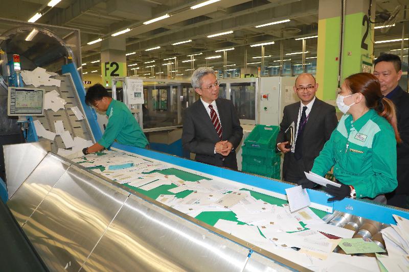 The Secretary for the Civil Service, Mr Joshua Law, today (December 5) visited Hongkong Post. Photo shows Mr Law (second left) being briefed on how automatic Culler Facer Cancellers expedite the mail processing procedure.