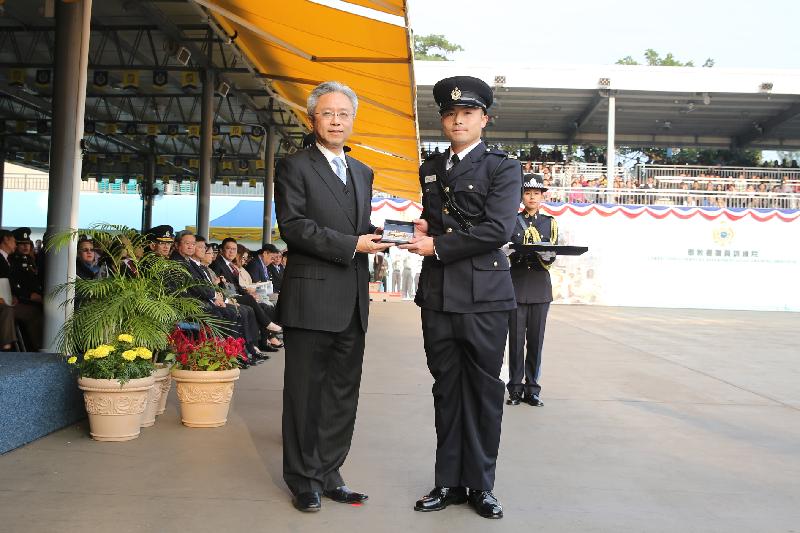 The Secretary for the Civil Service, Mr Joshua Law (left), presents a Best Recruit Award, the Golden Whistle, to Assistant Officer II Mr Yu Ho-pong at the Correctional Services Department passing-out parade at its Staff Training Institute in Stanley today (December 7).