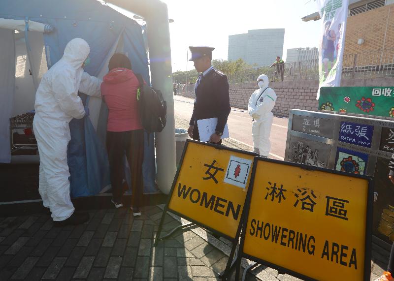 The Government conducted an inter-departmental exercise, "Checkerboard II", today (December 20). Photo shows evacuees undergoing decontamination procedures at Ma Liu Shui Ferry Pier.  