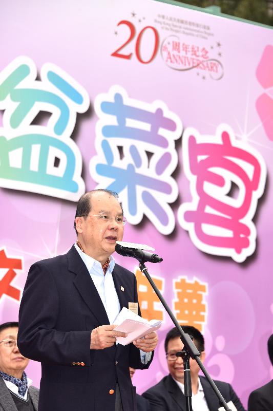 The Chief Secretary for Administration, Mr Matthew Cheung Kin-chung, speaks at a poon choi feast and carnival held by the Hong Kong Community Network today (December 23).