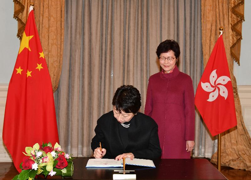 The Secretary for Justice, Ms Teresa Cheng, SC (left), signs the oaths after her swearing-in today (January 6).