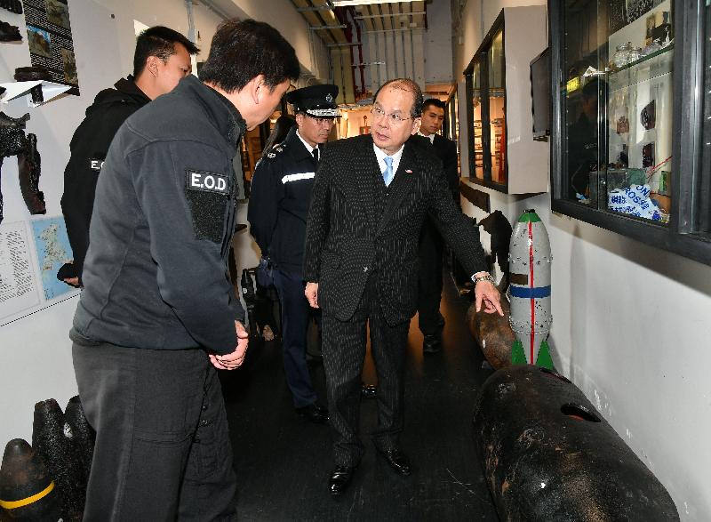 The Chief Secretary for Administration, Mr Matthew Cheung Kin-chung (front right), joined by the Deputy Commissioner of Police (Operations), Mr Lau Yip-shing (back row, second right), inspects the wartime bomb shells taken to the base of the Explosive Ordnance Disposal Bureau of the Hong Kong Police Force and receives a briefing from the Senior Bomb Disposal Officer, Mr Tony Chow (front left), today (February 2).