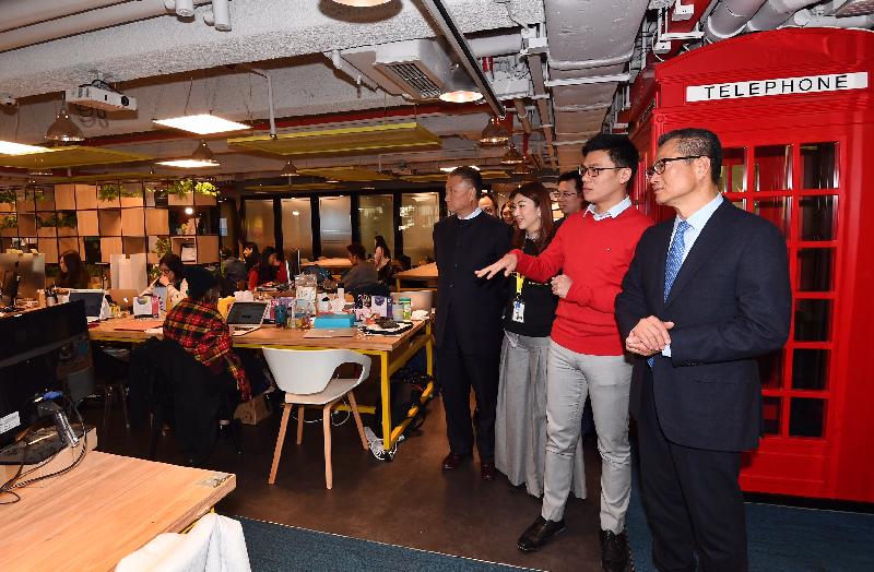 The Financial Secretary, Mr Paul Chan, today (February 7) visited The Wave, a co-working space, to understand more about the development of start-ups operating there. Photo shows Mr Chan (first right), accompanied by the Chairman of the Kwun Tong District Council, Dr Bunny Chan (fourth right), being briefed by the chairman of the company operating The Wave, Mr Tang Yiu-sing (second right), on The Wave's facilities and business operation.