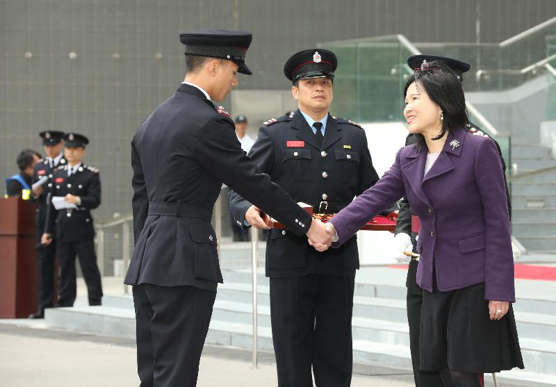 The Permanent Secretary for Security, Mrs Marion Lai, reviewed the 181st Fire Services passing-out parade at the Fire and Ambulance Services Academy today (March 2). Photo shows Mrs Lai (right) presenting the Best Recruit award to a graduate.