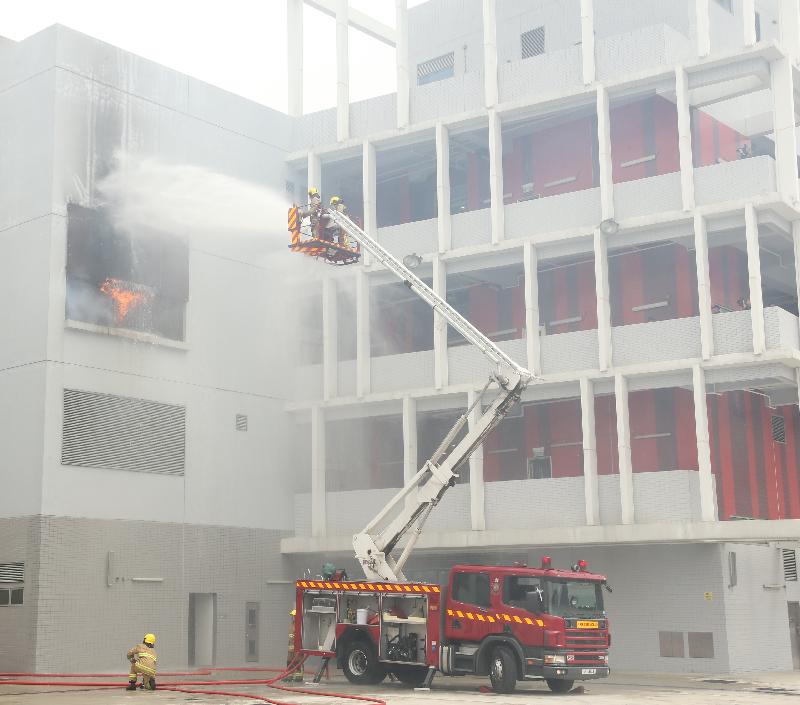 The Permanent Secretary for Security, Mrs Marion Lai, reviewed the 181st Fire Services passing-out parade at the Fire and Ambulance Services Academy today (March 2). Photo shows graduates demonstrating firefighting and rescue techniques.