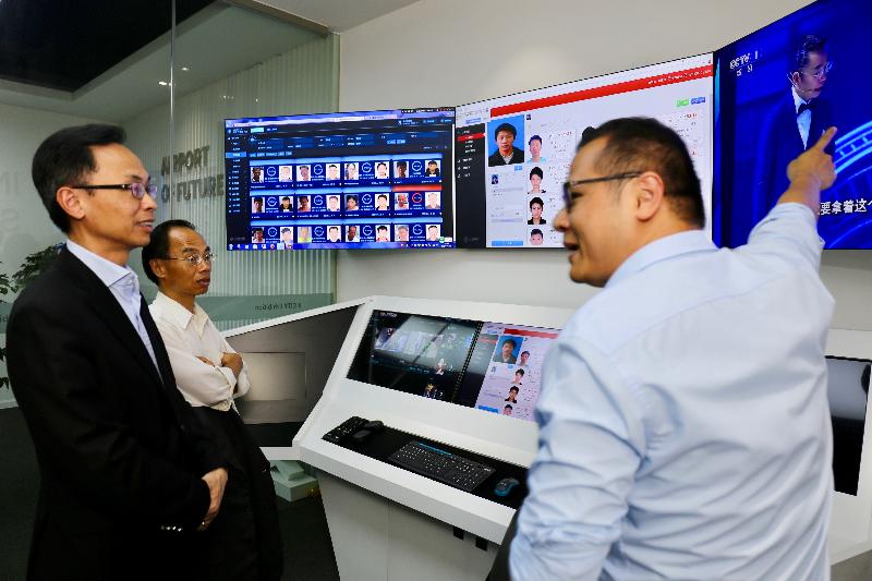 The Secretary for Constitutional and Mainland Affairs, Mr Patrick Nip, visited an information technology company in Nansha today (March 19). Photo shows Mr Nip (left) being briefed on the application of face recognition technology.