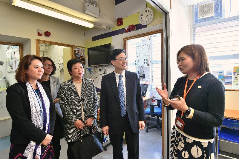 During his visit to Tai Po this afternoon (March 23), the Secretary for Security, Mr John Lee (second right), accompanied by the District Officer (Tai Po), Ms Andy Lui (centre), tours the social service centre of the Society of Rehabilitation and Crime Prevention Hong Kong. He is pictured receiving a briefing on the services provided by the facility. 