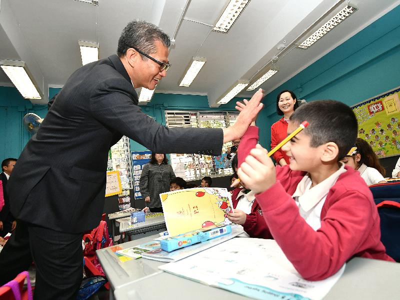 財政司司長陳茂波今日（三月二十八日）到訪李陞大坑學校。圖示陳茂波與該校學生交流。