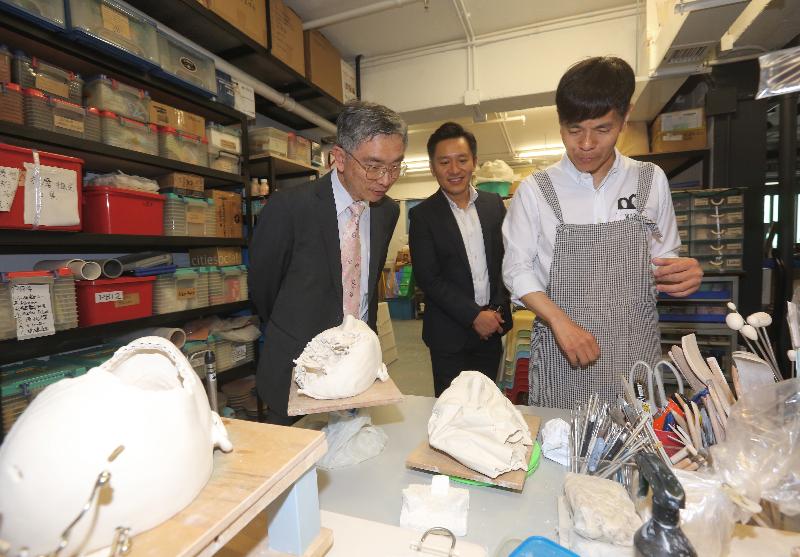 The Secretary for Financial Services and the Treasury, Mr James Lau (first left), is briefed on the art work and operation of the artists' studios at the Jockey Club Creative Arts Centre during his visit to the venue in Sham Shui Po District this afternoon (April 13). 
