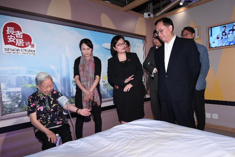 The Secretary for Innovation and Technology, Mr Nicholas W Yang (first right), receives a briefing on the Jockey Club Community eHealth Care Project, including its application of cloud technology and big data analytics, during his tour of the Senior Citizen Home Safety Association Jockey Club Oi Man Centre today (April 30).