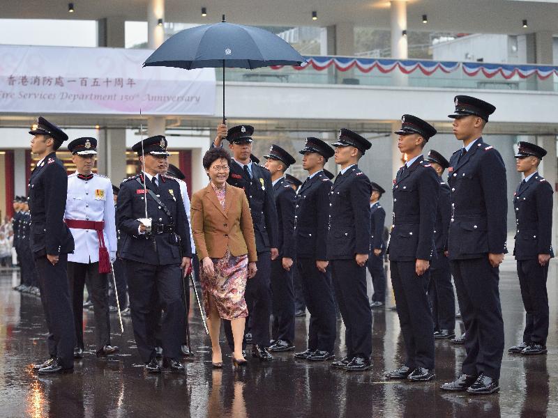 The Chief Executive, Mrs Carrie Lam (fourth left), reviews the Hong Kong Fire Services Department 150th anniversary grand parade at the Fire and Ambulance Services Academy today (‪May 9‬).
