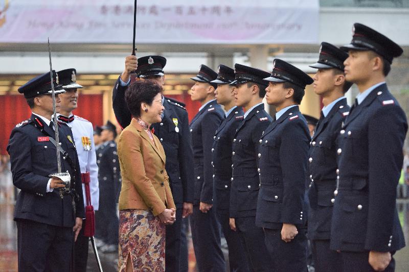 The Chief Executive, Mrs Carrie Lam (second left), reviews the Hong Kong Fire Services Department 150th anniversary grand parade at the Fire and Ambulance Services Academy today (‪May 9‬).