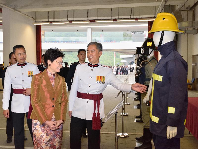 The Chief Executive, Mrs Carrie Lam, attended the Hong Kong Fire Services Department 150th anniversary grand parade at the Fire and Ambulance Services Academy today (‪May 9‬). Photo shows Mrs Lam (left) receiving a briefing by the Director of Fire Services, Mr Li Kin-yat (right), on fire services uniforms from different periods.