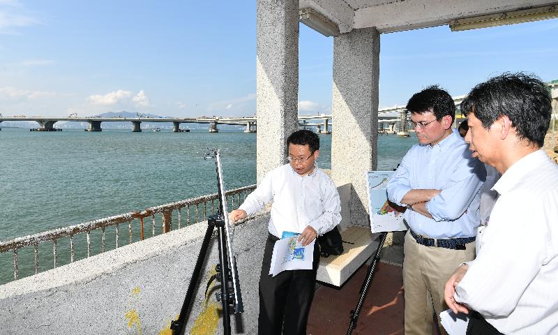 The Secretary for Commerce and Economic Development, Mr Edward Yau (centre), visited Pak Mong Pier at Tung Chung to observe the Hong Kong Boundary Crossing Facilities (HKBCF) Island of Hong Kong-Zhuhai-Macao Bridge during his visit to Islands District today (May 17). Mr Yau is pictured being briefed by representatives of the Planning Department and the Civil Engineering and Development Department on the ongoing study of topside development on the HKBCF Island, as well as on housing and economic development plans along the northern shore of Lantau.