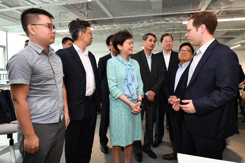 The Chief Executive, Mrs Carrie Lam, visited an innovation and technology company at Guangzhou Science City in Guangzhou today (May 17). Photo shows Mrs Lam (centre) chatting with staff who are from Hong Kong.