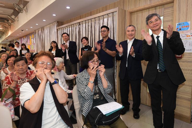 The Secretary for Labour and Welfare, Dr Law Chi-kwong, visited Yau Tsim Mong District today (May 18) and called at the Mong Kok Kai Fong Association Chan Hing Social Service Centre. Photo shows (back row, from right) Dr Law; the Chairman of Mong Kok Kai Fong Association, Mr Leung Wah-sing; the Chairman of Yau Tsim Mong District Council, Mr Chris Ip; the District Officer (Yau Tsim Mong), Mrs Laura Aron; and the Under Secretary for Labour and Welfare, Mr Caspar Tsui, watching seniors attending a harmonica class.