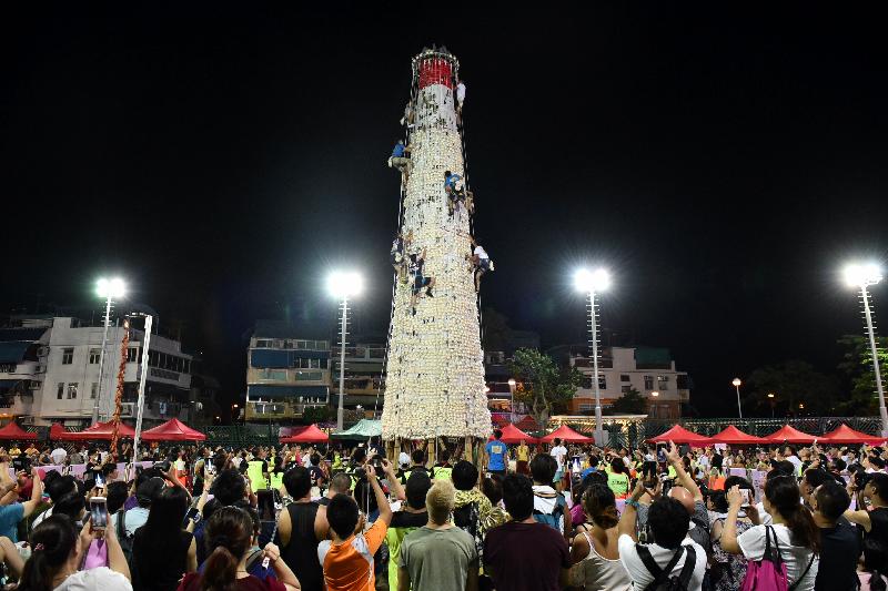 The Bun Scrambling Competition in Cheung Chau concluded early this morning (May 23). Photo shows the finalists scrambling up the bun tower to snatch as many buns as they can within a three-minute time limit to vie for the championships.