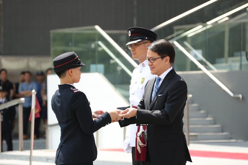 The Chairman of the Legislative Council Panel on Security, Mr Chan Hak-kan (first right), reviewed the 182nd Fire Services passing-out parade at the Fire and Ambulance Services Academy today (May 25). Picture shows Mr Chan presenting the Best Recruit award to a graduate.