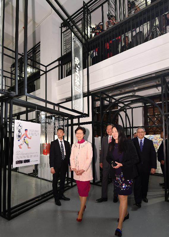 The Chief Executive, Mrs Carrie Lam, attended the Tai Kwun Opening Ceremony today (May 25). Photo shows Mrs Lam (second left) touring "100 Faces of Tai Kwun" exhibition.