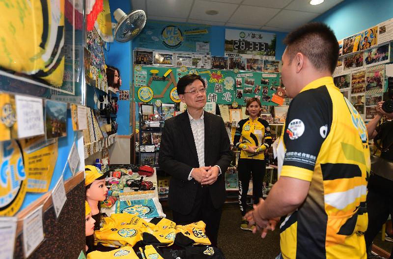 During his visit to North District this afternoon (June 1), the Secretary for Security, Mr John Lee (left), tours the Cheer Lutheran Centre, where he is briefed on the "We Cycle II" bicycle guided tour and volunteer training scheme.