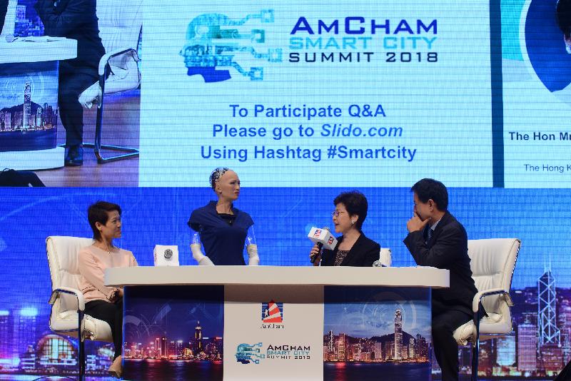 The Chief Executive, Mrs Carrie Lam, attended the AmCham Smart City Summit 2018 today (June 27). Photo shows Mrs Lam (second right) chatting with the first artificial intelligence citizen of Saudi Arabia, Sophia (second left), at the summit. 
