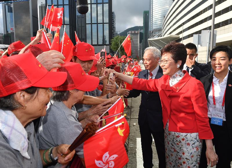 The Chief Executive, Mrs Carrie Lam (second right), greets members of the public before the flag-raising ceremony for the 21st anniversary of the establishment of the Hong Kong Special Administrative Region at Golden Bauhinia Square in Wan Chai this morning  (July 1). Joining her is her husband Dr Lam Siu-por (third right).