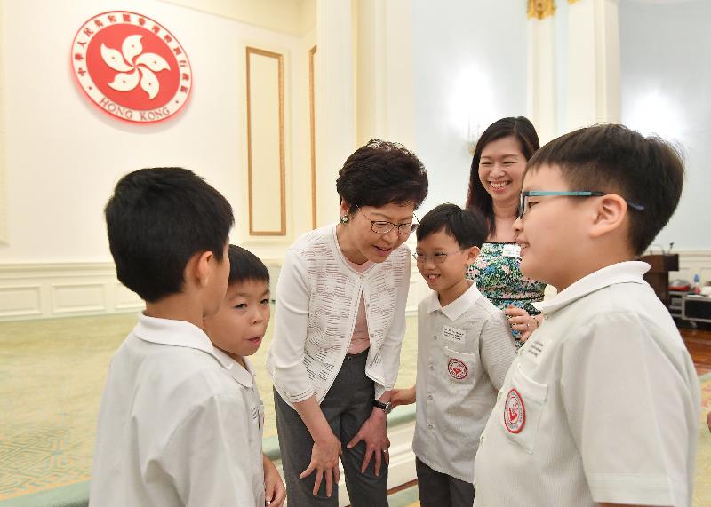 The Chief Executive, Mrs Carrie Lam, together with the Secretaries of Department and the Directors of Bureau met over 100 Hong Kong young people and students, who won international competitions in the past year, in a tea gathering at Government House this afternoon (July 1). Photo shows Mrs Lam (third left) chatting with the participants.