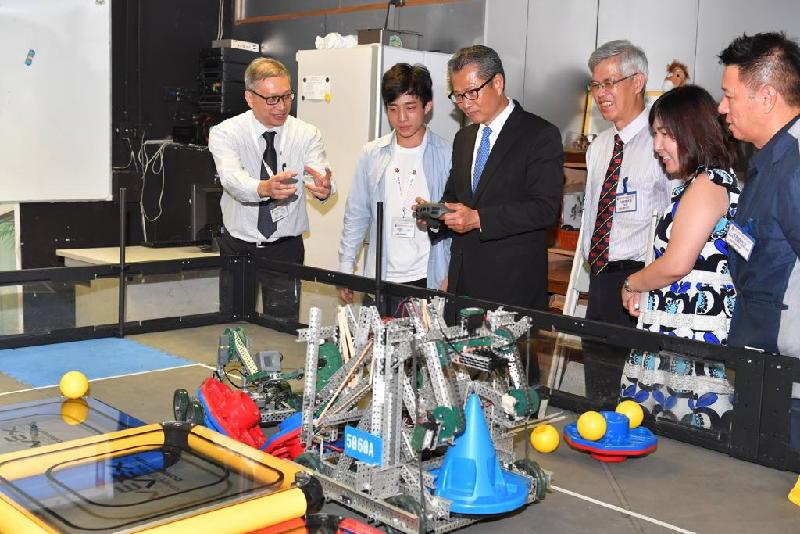 The Financial Secretary, Mr Paul Chan (third left), accompanied by the District Officer (Tuen Mun), Ms Aubrey Fung (second right), today (July 5) visits the Church of Christ in China Tam Lee Lai Fun Memorial Secondary School and is briefed by school representatives on its STEM (science, technology, engineering and mathematics) education. 