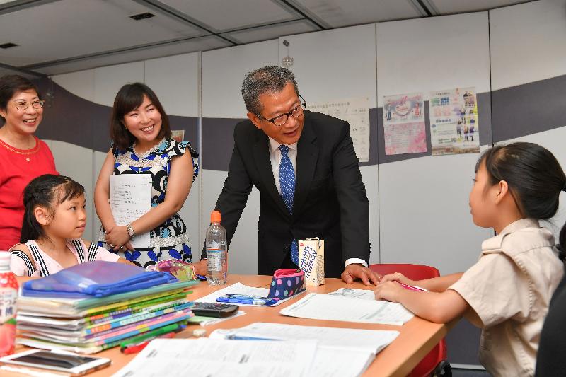 The Financial Secretary, Mr Paul Chan (second right), accompanied by the District Officer (Tuen Mun), Ms Aubrey Fung (third right), today (July 5) visits Free Methodist Church Tuen Mun Children and Youth Integrated Services Centre and chats with children there. 