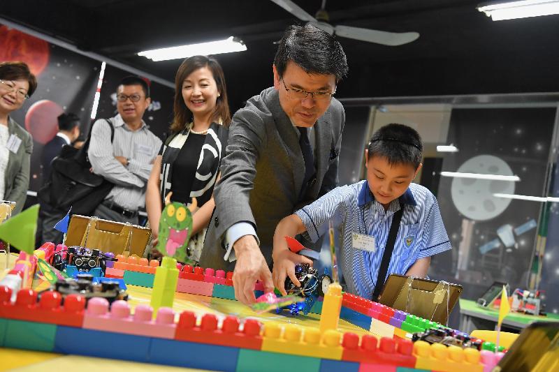 The Secretary for Commerce and Economic Development, Mr Edward Yau, today (July 9) visited Po Kok Primary School during his visit to Wan Chai District. Photo shows Mr Yau (second right) viewing a demonstration of students' science, technology, engineering and mathematics (STEM) projects.
