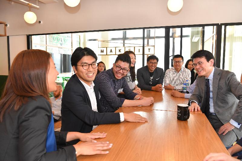 The Secretary for Commerce and Economic Development, Mr Edward Yau, today (July 9) toured the co-working space set up by WeWork in Causeway Bay during his visit to Wan Chai District. Photo shows Mr Yau (first right) and the District Officer (Wan Chai), Mr Rick Chan (second right), listening to start-up entrepreneurs sharing details of their business vision.