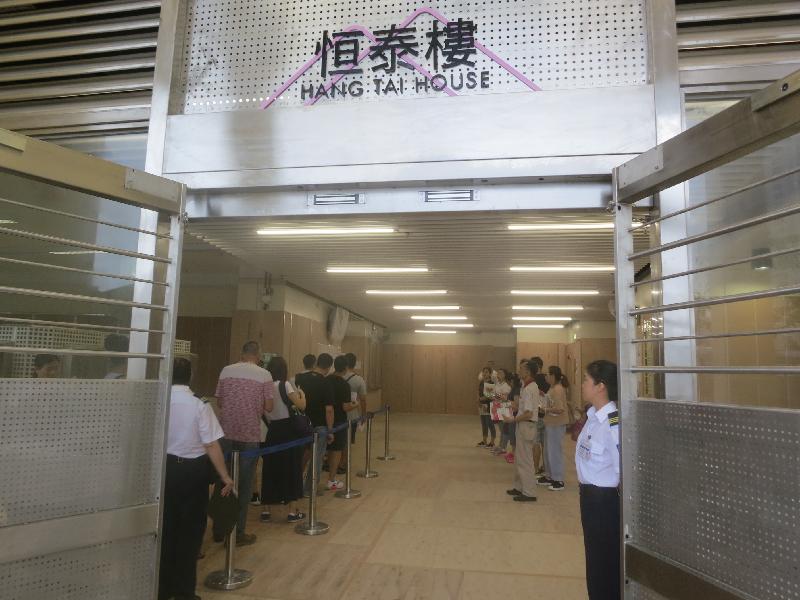 The intake of tenants into the four newly completed blocks at On Tai Estate, Kwun Tong, began today (July 10). Photo shows residents completing the intake formalities.