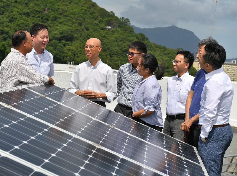 The Secretary for the Environment, Mr Wong Kam-sing (third left), today (July 16) views the solar photovoltaic system at So Uk Estate.