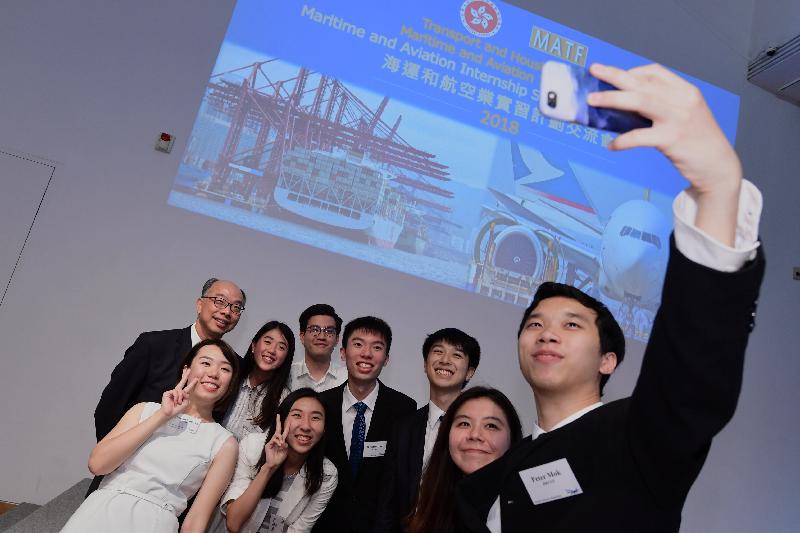 The Secretary for Transport and Housing, Mr Frank Chan Fan (back row, left), poses for a selfie with a group of students at the Maritime and Aviation Internship Scheme Cocktail Reception today (July 20).  