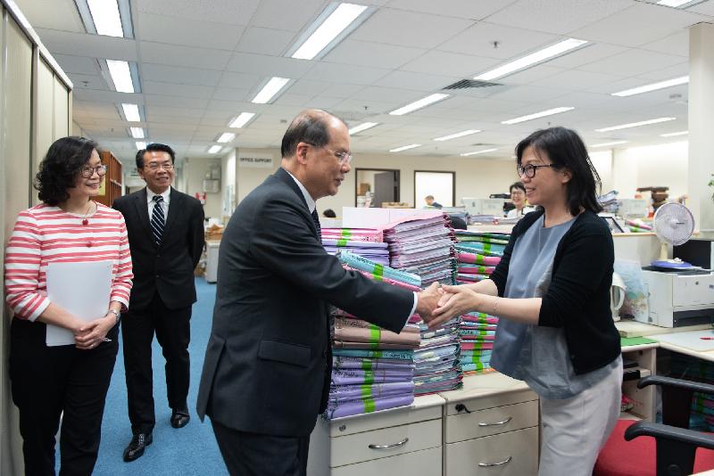 The Chief Secretary for Administration, Mr Matthew Cheung Kin-chung (second right), today (July 23) visits the Application and Processing Division of the Legal Aid Department to learn about the work of front-line staff in handling legal aid application. He encourages them to keep up their dedication to serve the public. Joining him are the Director of Legal Aid, Mr Thomas Kwong (second left), and the Deputy Director of Legal Aid (Application and Processing), Ms Mo Yuk-wah (first left).