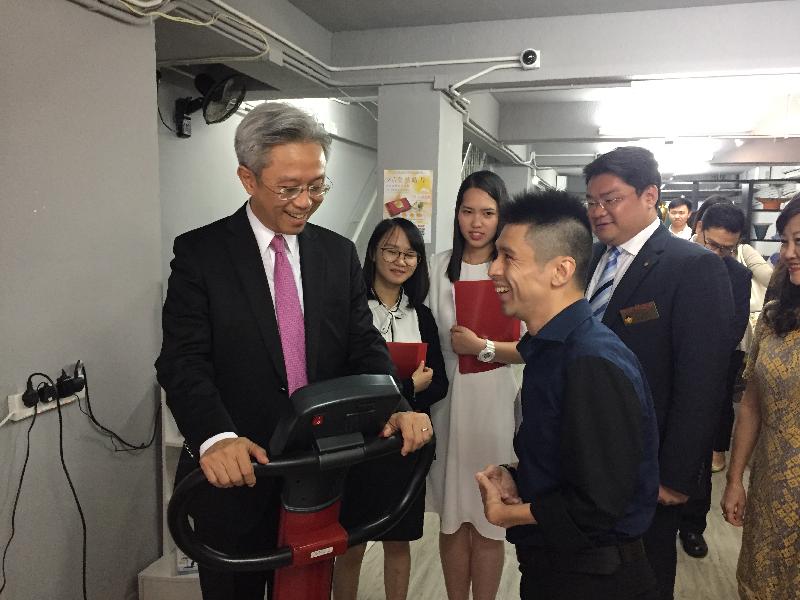 The Secretary for the Civil Service, Mr Joshua Law, visited Kowloon City District today (July 24). Photo shows Mr Law (first left) learning more about the operation of LST RehaCare, a social enterprise of the Lok Sin Tong Benevolent Society, Kowloon. Looking on are two secondary school students participating in the "Be a Government Official for a Day" programme (second left and third left).